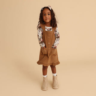 Fall & Winter Dresses, girl in a camel corduroy overall dress with a floral long sleeve top | Baby Riddle