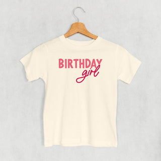 Birthday Girl Tee (Pink Sans Serif + Script) (Kids) POD - Apparel Ivy + Cloth Style: Toddler Tee Color: Natural Size: 2T