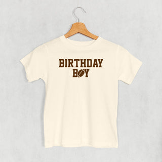 The Birthday Boy Football Tee (Kids) POD - Apparel Ivy + Cloth Style: Toddler Tee Color: Natural Size: 2T