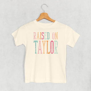 Raised On Taylor Tee (Kids) POD - Apparel Ivy + Cloth Style: Toddler Tee Color: Natural Size: 2T