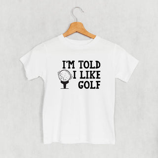 I'm Told I Like Golf Tee (Kids) POD - Apparel Ivy + Cloth Style: Toddler Tee Color: White Size: 2T
