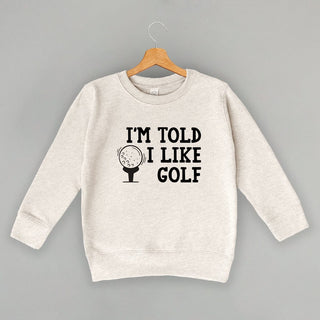 I'm Told I Like Golf Tee (Kids) POD - Apparel Ivy + Cloth Style: Toddler Crewneck Color: Natural Heather Size: 2T